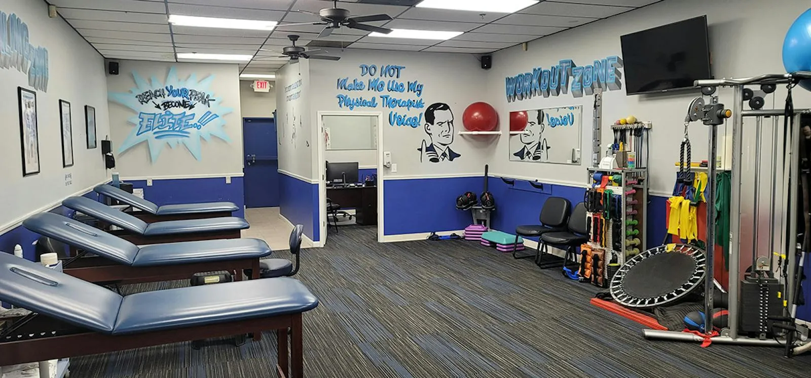 The Workout Zone, with a cable machine, resistance bands, dumbbells and a mini trampoline beside treatment tables